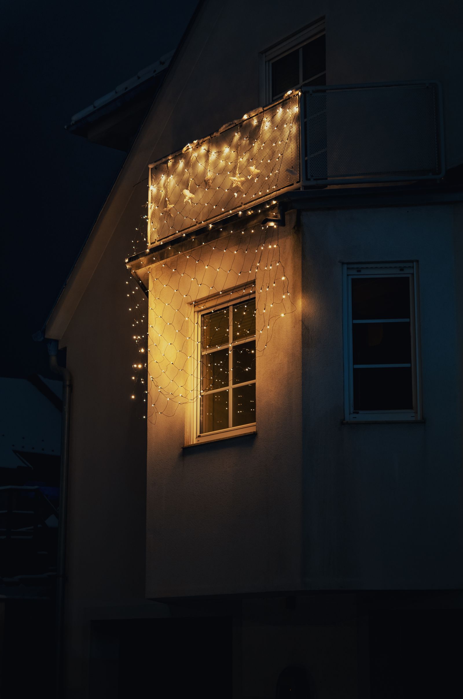 House exterior with glowing decorative lights at night
